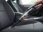 Car vacuum with crevice tool cleaning between seat cushions